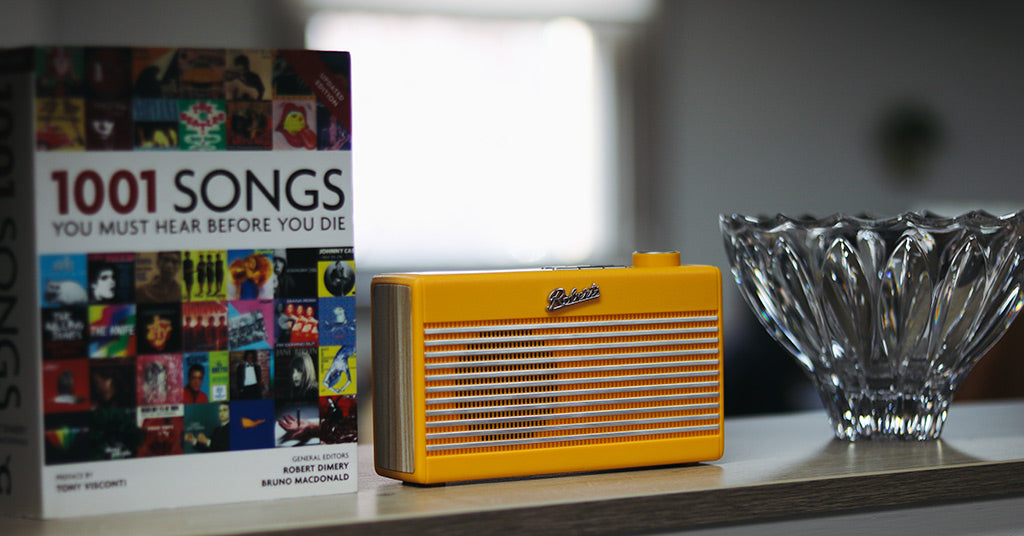 Roberts Rambler Mini radio sitting on shelf next to book