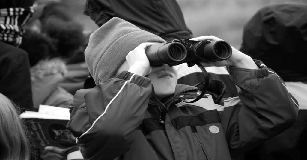 Child stargazing with binoculars