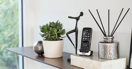 Gigaset cordless phone handset on side table