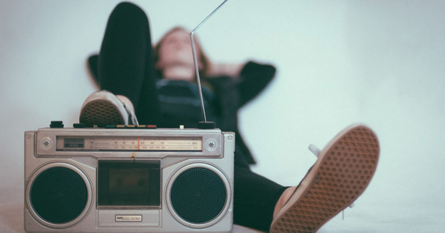 Woman lying back with foot resting on radio