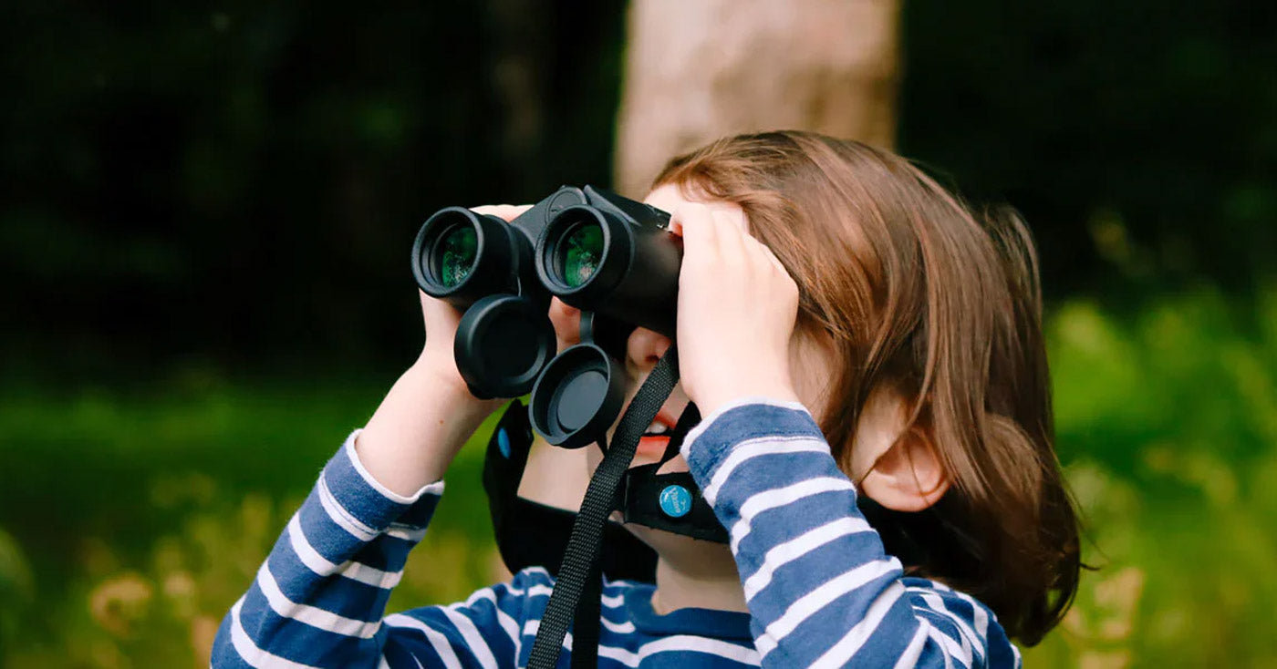 A child holding binoculars