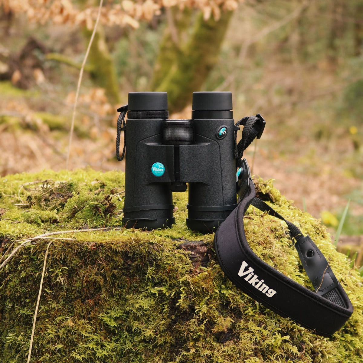 Viking Kestrel binoculars stood on mossy tree stump
