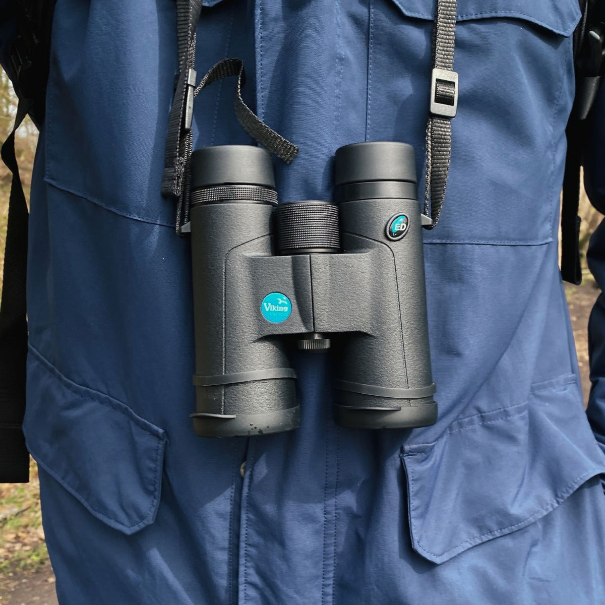 Close-up of binoculars hanging from neck strap